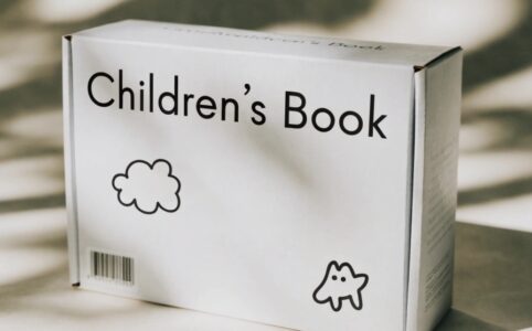 Whitechildren'ss book box in a bright nursery with organized picture books and cozy reading corner